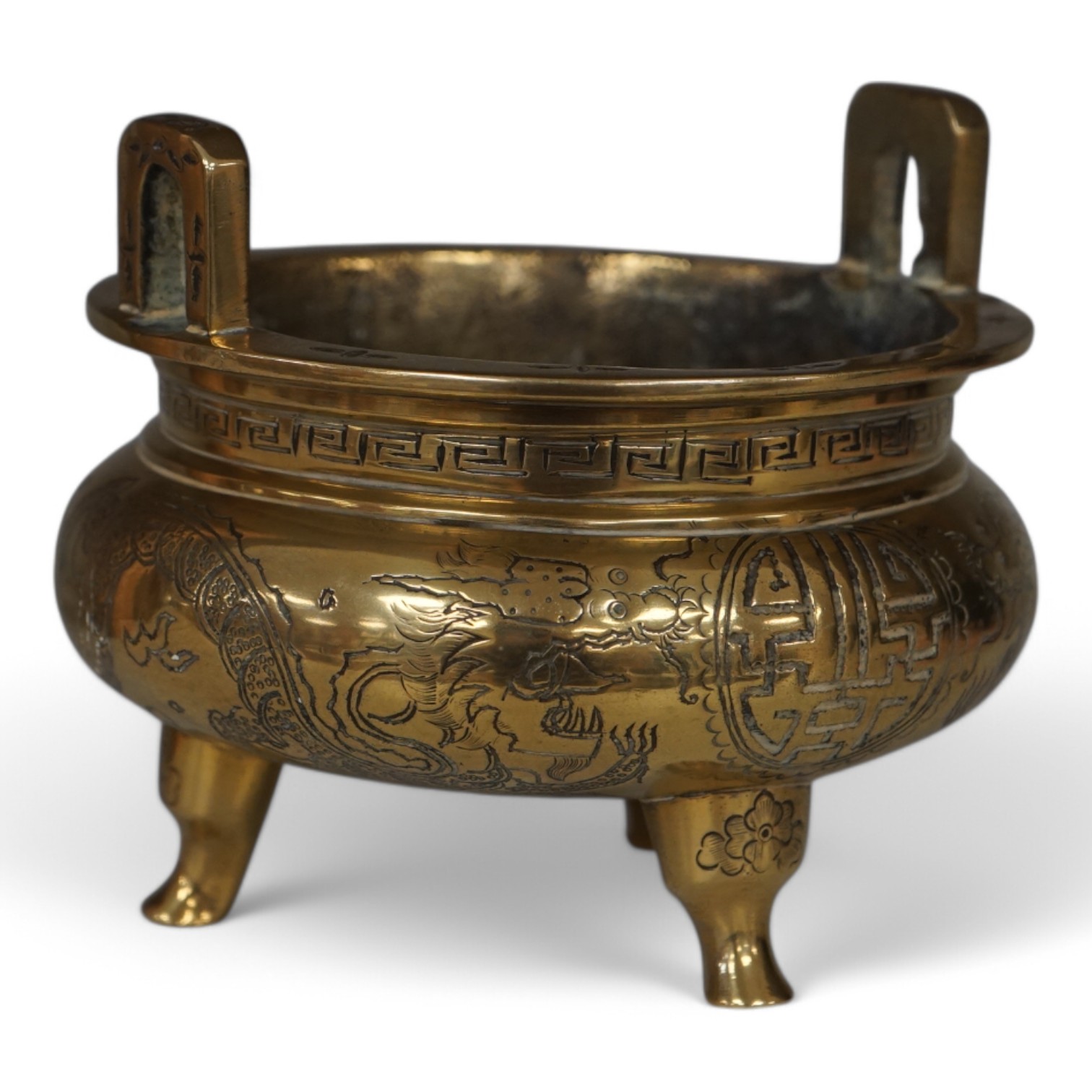 A Chinese engraved and chased bronze tripod censer, Xuande mark, early 20th century, 10.5cm. Condition - good